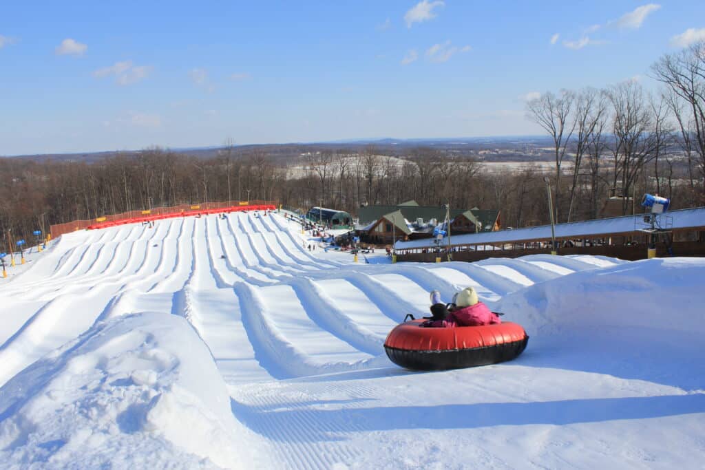 Snow tubing lanes on a groomed hillside