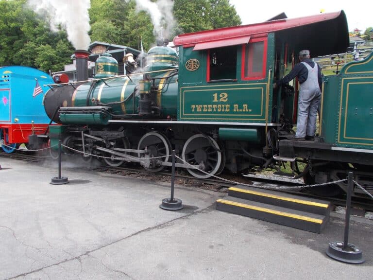 Tweetsie Railroad steam locomotive with an engineer climbing aboard